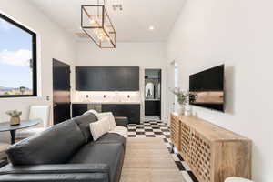 Living room featuring a towering ceiling and a chandelier