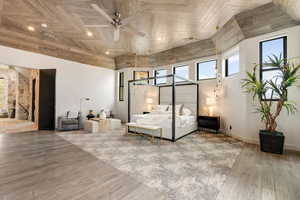 Unfurnished bedroom with wood-type flooring and a towering ceiling