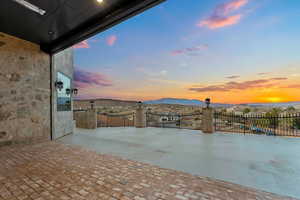 Patio terrace at dusk with a mountain view