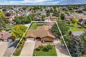 Aerial perspective of suburban area featuring property boundaries highlighted