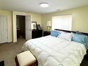 Bedroom featuring carpet floors and a textured ceiling