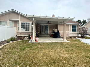 Back of house with a patio area and a yard