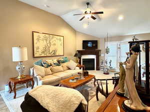 Living room with vaulted ceiling and ceiling fan