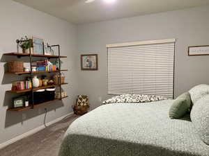 Carpeted bedroom with baseboards