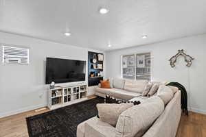 Living room with wood-type flooring and a textured ceiling