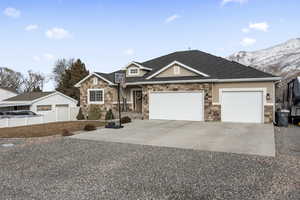 View of front of house with a mountain view and a garage