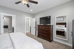 Bedroom with ceiling fan, carpet, and ensuite bathroom