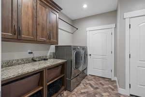 Clothes washing area with cabinets and independent washer and dryer