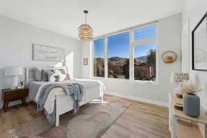 Bedroom with light hardwood / wood-style flooring