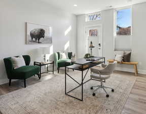 Home office with light wood-type flooring