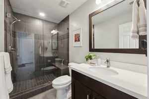 Bathroom featuring vanity, tile patterned floors, a shower with door, and toilet