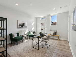 Office area with light hardwood / wood-style flooring