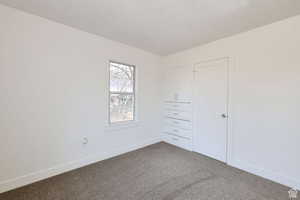 Unfurnished bedroom featuring carpet floors and a textured ceiling