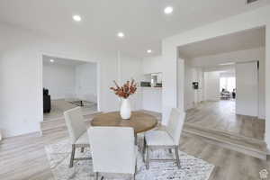 Dining space with light hardwood / wood-style flooring