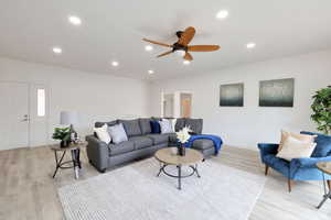 Living room featuring light hardwood / wood-style floors and ceiling fan