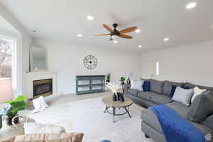 Living room featuring light hardwood / wood-style floors, a wealth of natural light, and ceiling fan