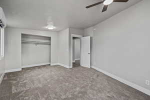 Unfurnished bedroom with a closet, ceiling fan, and carpet floors