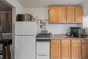 Kitchen featuring white appliances