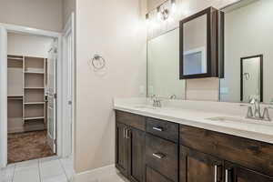Bathroom with tile patterned flooring and vanity