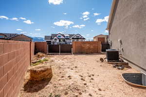 View of yard featuring central AC and a mountain view