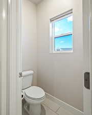 Bathroom featuring toilet and tile patterned flooring