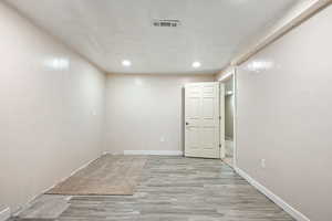Unfurnished room with light hardwood / wood-style floors