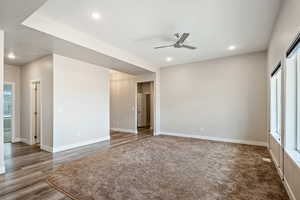 Empty room featuring dark hardwood / wood-style flooring and ceiling fan