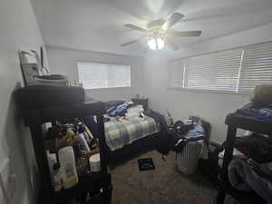 unit 1 Bedroom with ceiling fan and carpet