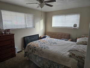 Unit 3 Bedroom with a textured ceiling, carpet flooring, and ceiling fan