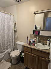 Unit 2 Full bathroom with toilet, vanity, and shower / bath combination with curtain