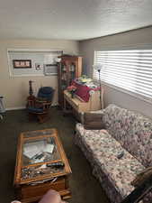 Unit 2 Carpeted living room with cooling unit and a textured ceiling