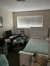 Unit 2 Carpeted bedroom featuring a textured ceiling