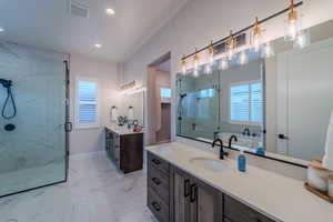 Bathroom featuring separate shower and tub and vanity