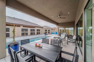 View of patio / terrace with a fenced in pool and ceiling fan