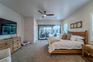 Carpeted bedroom with ceiling fan and access to exterior