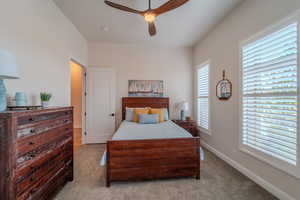 Bedroom featuring ceiling fan and light colored carpet