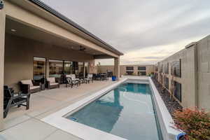 View of pool with ceiling fan and a patio area