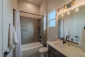 Full bathroom featuring shower / tub combo, vanity, and toilet