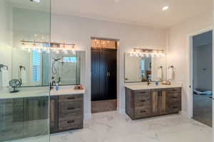 Bathroom with tiled shower and vanity