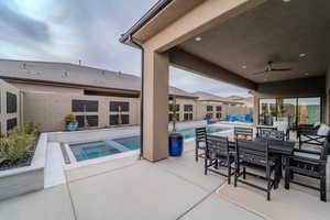 View of swimming pool with a patio, an in ground hot tub, and ceiling fan