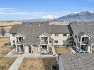 Front of property with a patio, a yard, a mountain view