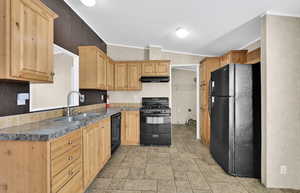 Kitchen featuring sink, crown molding, light brown cabinetry, and black appliances