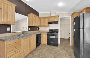 Kitchen with crown molding, sink, black appliances, and light brown cabinetry