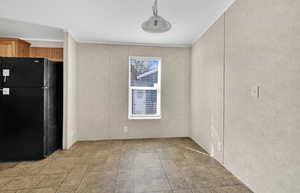 Unfurnished dining area with crown molding