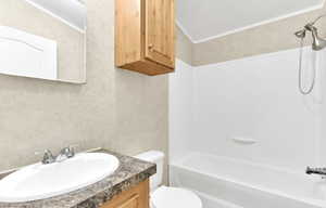 Full bathroom with bathing tub / shower combination, toilet, vanity, and crown molding