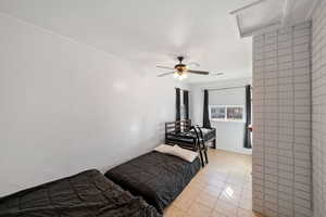 Tiled bedroom with ceiling fan