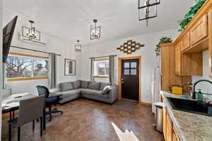 Office space with sink, a chandelier, and a wealth of natural light