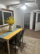 Dining room with ceiling fan and a textured ceiling