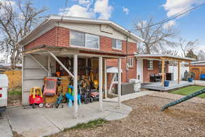 Back of house with a deck