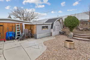 Back of property with a shed